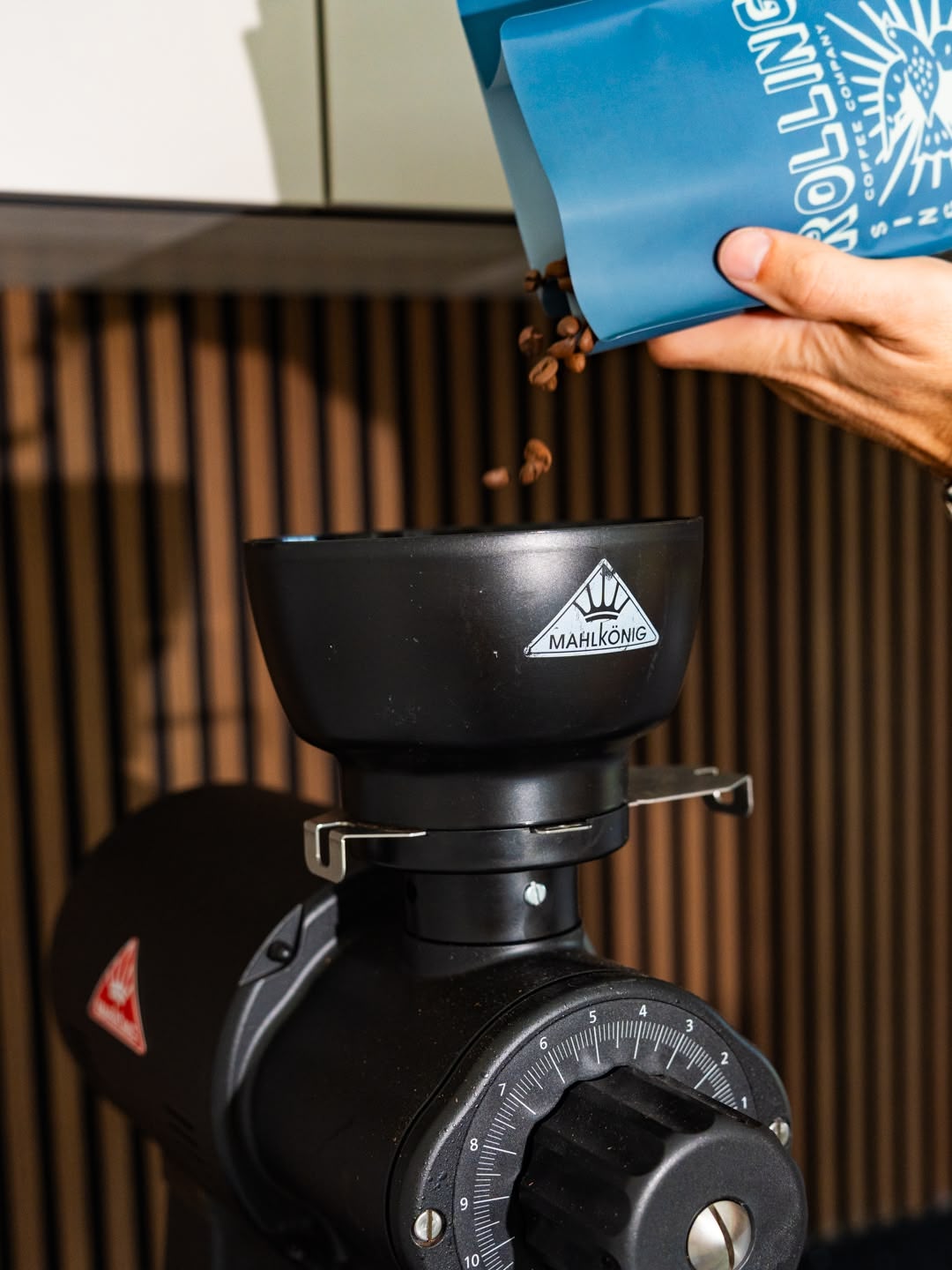 Loading a bag of Palmichal single origin coffee from Tarrazu, Costa Rica, roasted by Bocanegra Coffee Roasters, available at Rolling Waves Nosara into Mahlkonig EK43 hopper