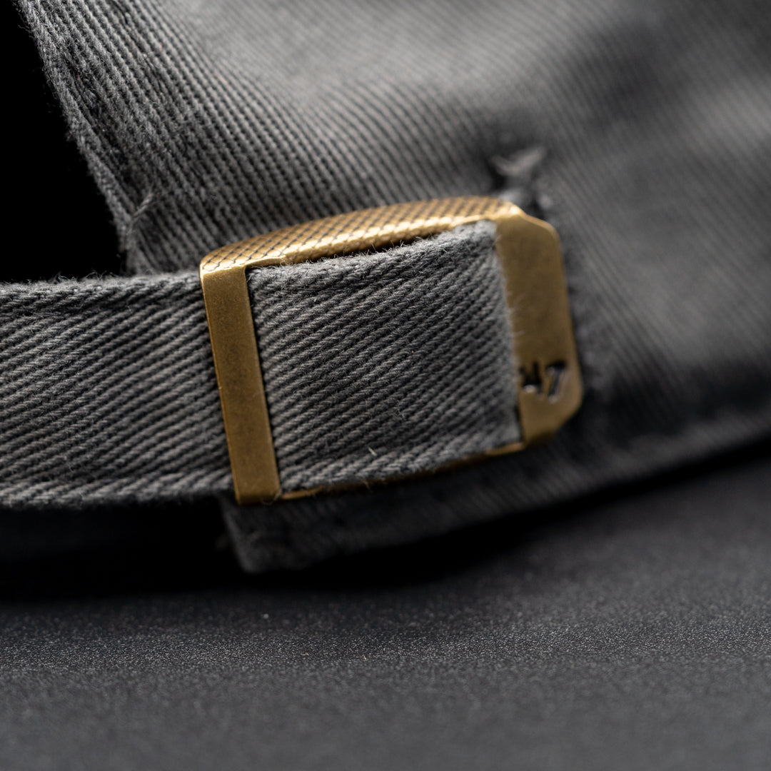 Adjustable belt enclosure of Rolling Waves Everyday Cap in dark grey with off-white block logo, garment-washed cotton twill unstructured cap with adjustable fit