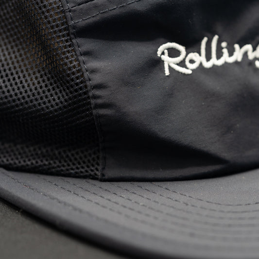 Detailed stitching for Rolling Waves Active 5-Panel Hat in dark blue with bone color designs, recycled nylon performance cap with mesh panels and UPF 50+ protection