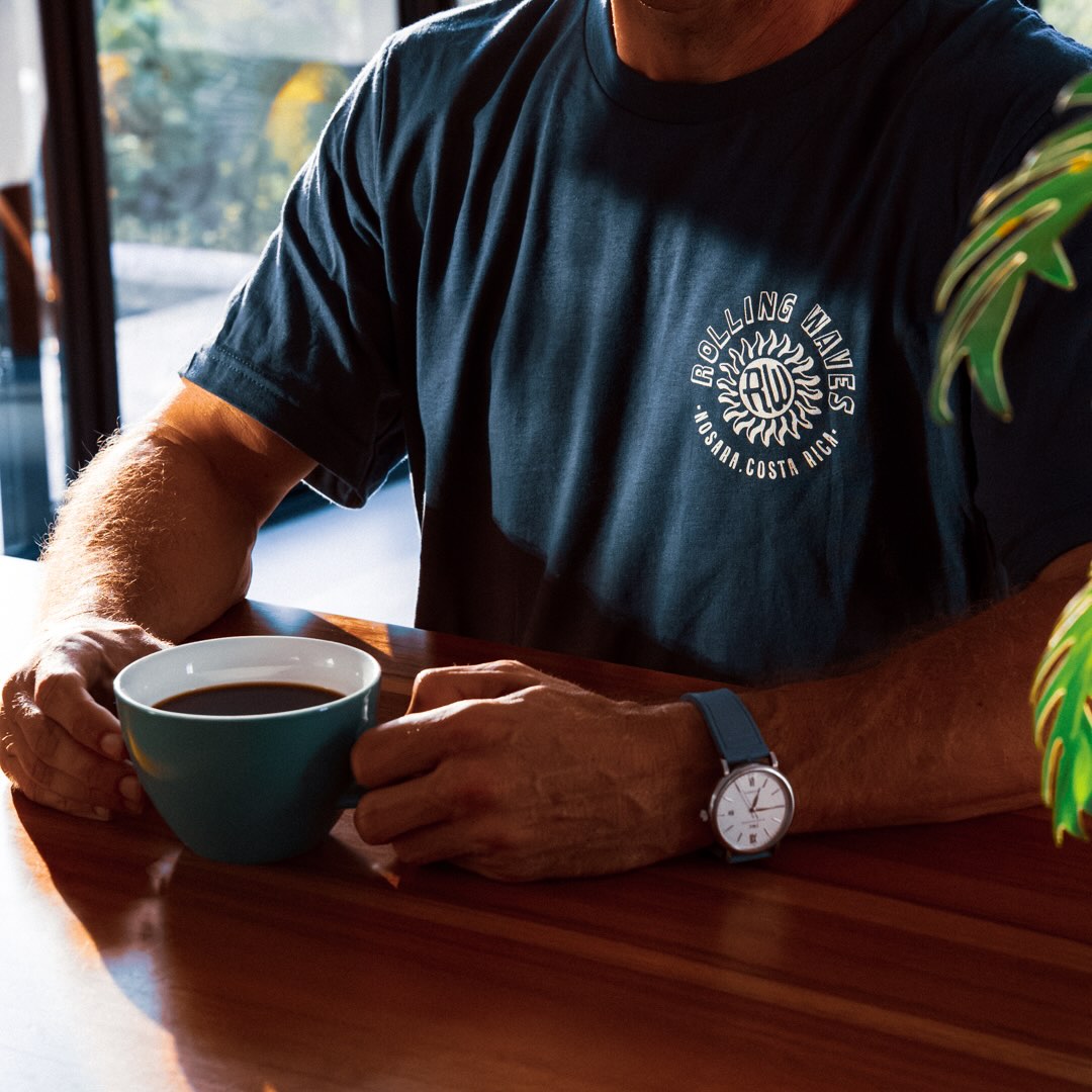 Person holding a coffee cup in a casual setting