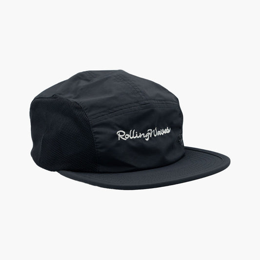 Side angle of Rolling Waves Active 5-Panel Hat in dark blue with bone color designs, recycled nylon performance cap with mesh panels and UPF 50+ protection