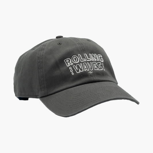 Side angle of Rolling Waves Everyday Cap in dark grey with off-white block logo, garment-washed cotton twill unstructured cap with adjustable fit