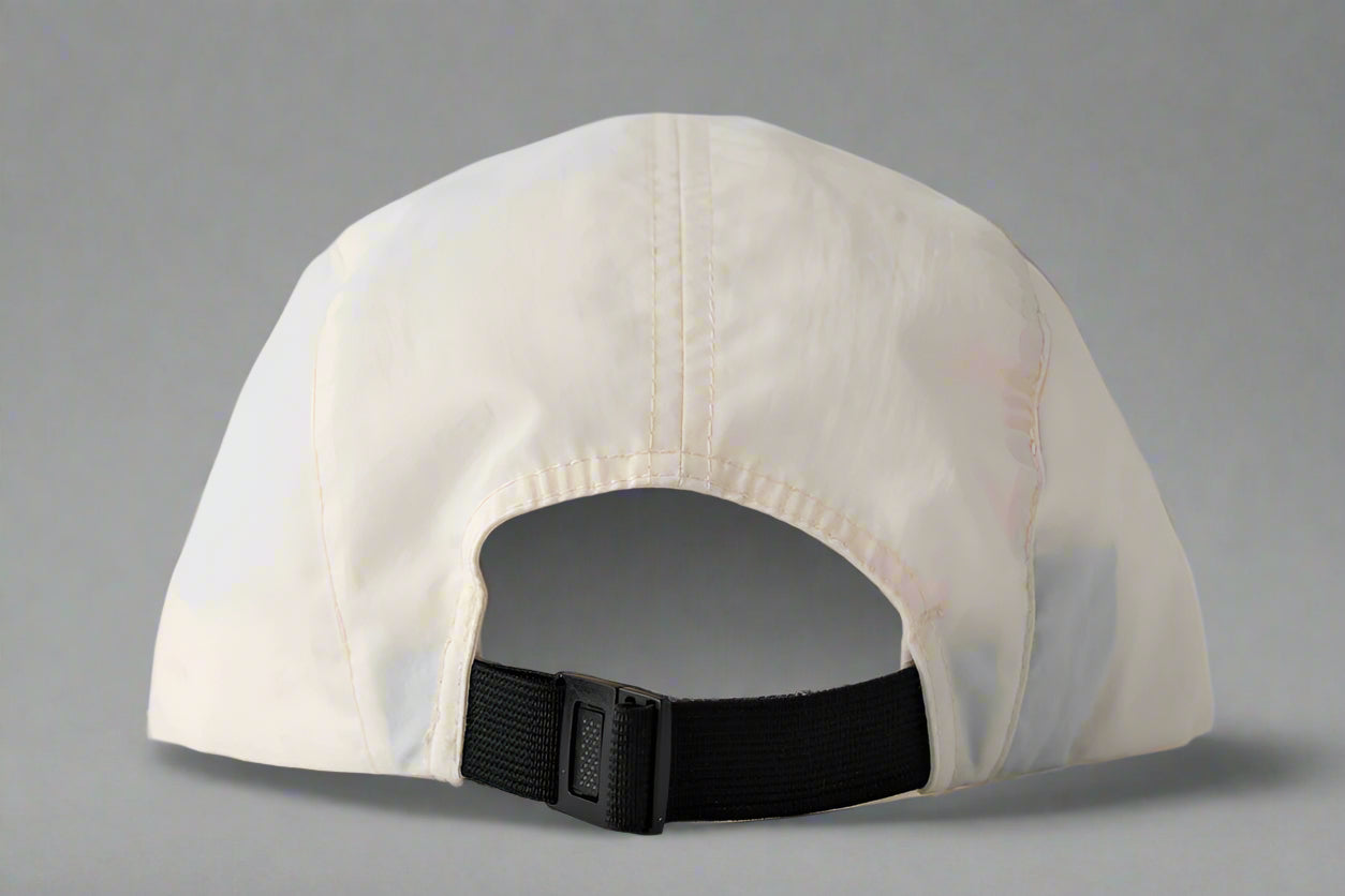 Beige cap with a black strap on a light gray background