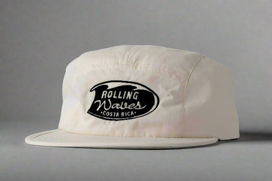 White cap with 'Rolling Waves Costa Rica' logo on a gray background